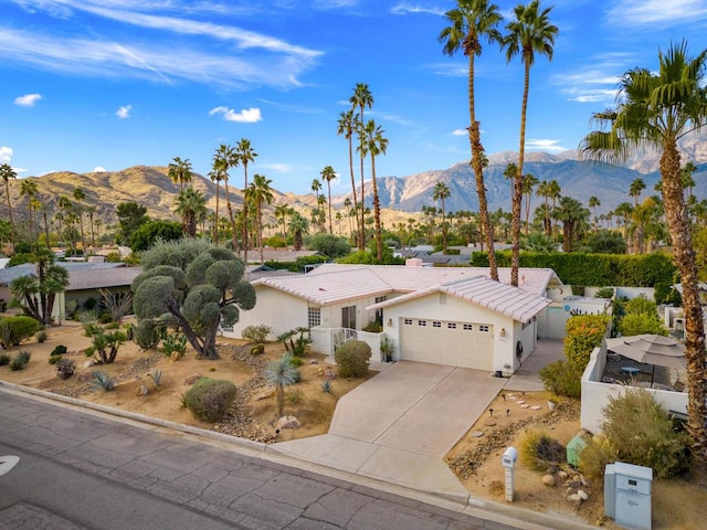 view of front of home with a mountain view and a garage