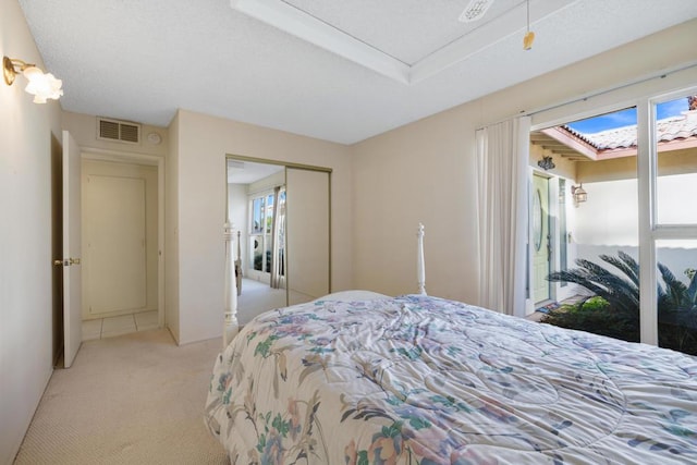 bedroom with light carpet and a closet