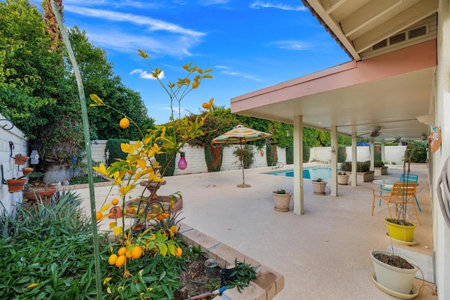 view of patio with a fenced in pool and ceiling fan