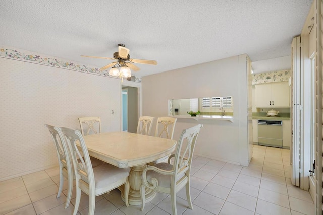 tiled dining room with a textured ceiling and ceiling fan