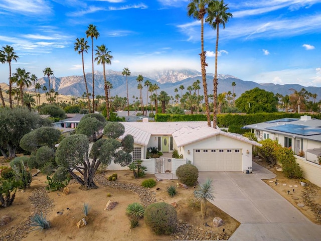 view of front facade featuring a mountain view and a garage