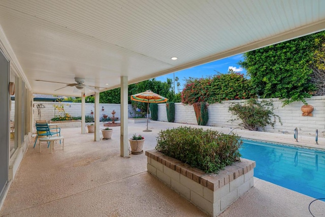 view of patio / terrace featuring ceiling fan and a fenced in pool