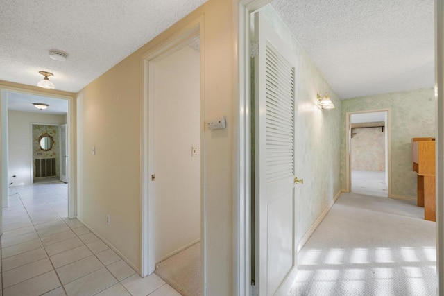 hall with light tile patterned floors