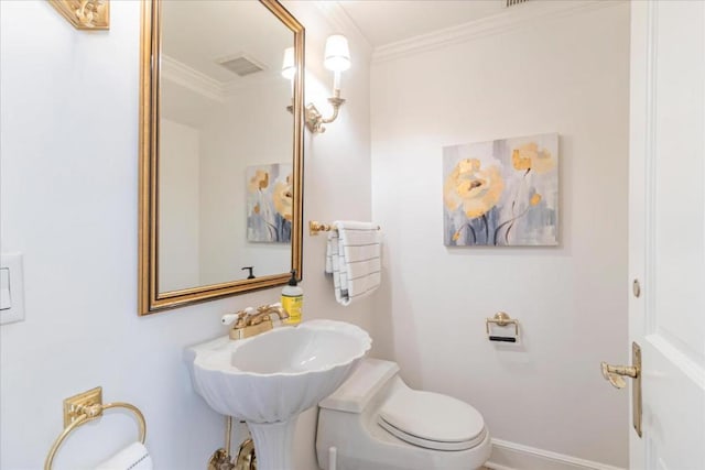 bathroom with crown molding and toilet