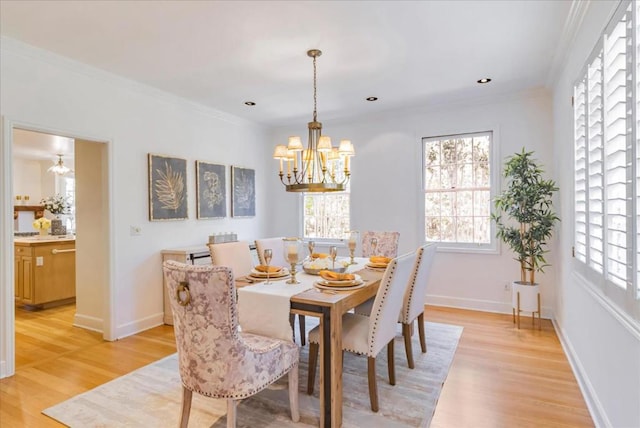 dining area with crown molding, plenty of natural light, and light hardwood / wood-style flooring