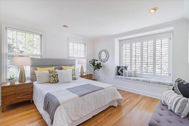 bedroom featuring wood-type flooring and crown molding