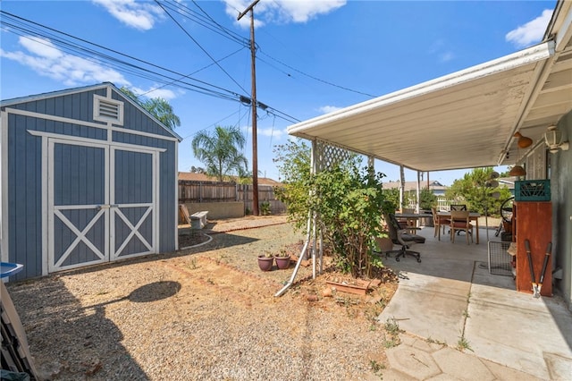 view of yard with a shed and a patio