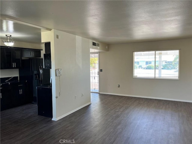 kitchen with black fridge with ice dispenser and dark hardwood / wood-style flooring