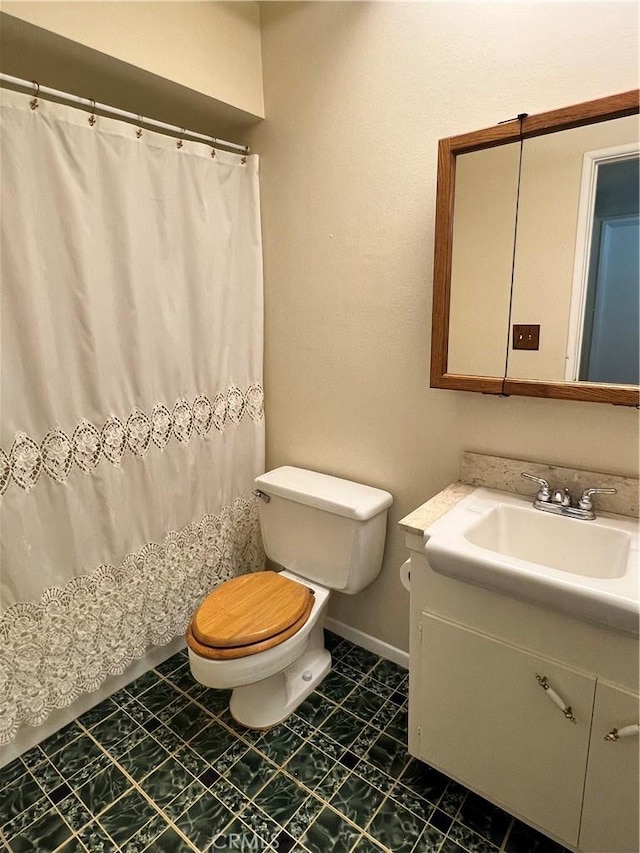 bathroom featuring toilet and vanity