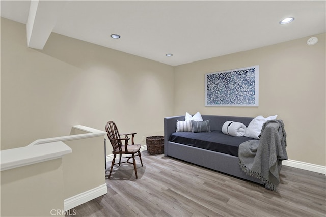 bedroom with baseboards, wood finished floors, and recessed lighting