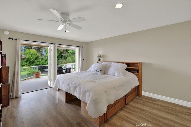 bedroom featuring baseboards, wood finished floors, a ceiling fan, and access to exterior