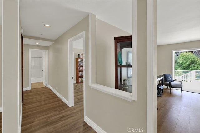 hallway with recessed lighting, dark wood finished floors, and baseboards