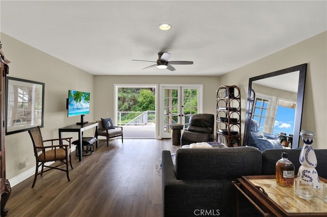 living area featuring a ceiling fan, french doors, dark wood finished floors, and baseboards