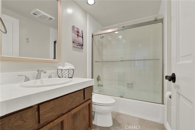 bathroom with toilet, tile patterned flooring, enclosed tub / shower combo, and vanity