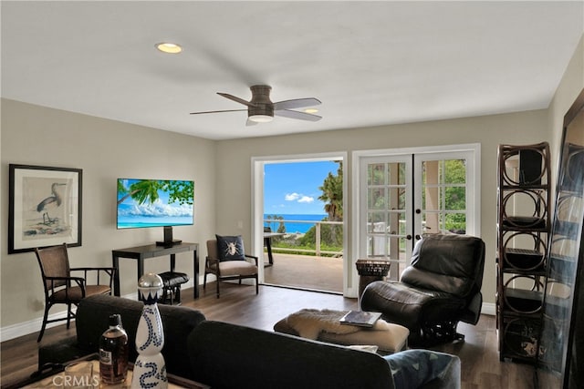 living area with dark wood-style floors, baseboards, a ceiling fan, and french doors