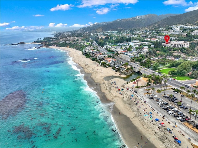 drone / aerial view with a water view and a beach view