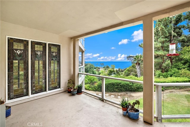 unfurnished sunroom with a water view