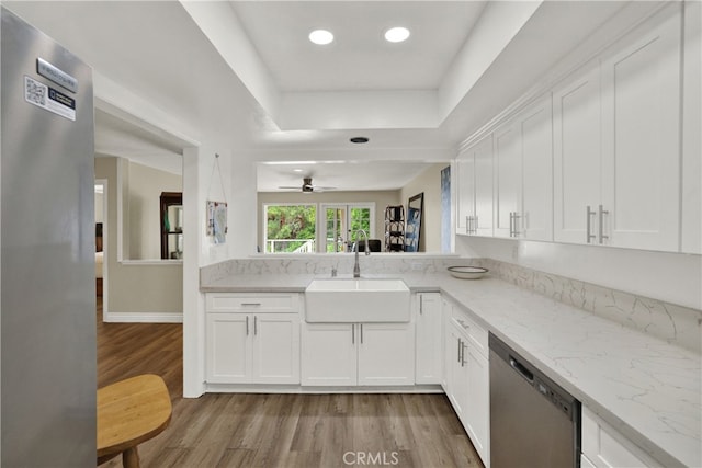 kitchen with white cabinets, stainless steel appliances, and a sink