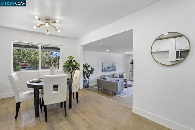 dining area featuring a chandelier and light hardwood / wood-style flooring