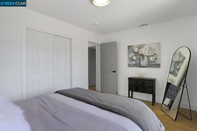 bedroom featuring hardwood / wood-style flooring and a closet