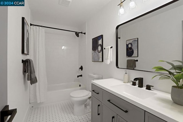 full bathroom featuring shower / tub combo with curtain, vanity, and toilet