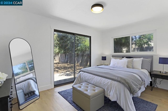 bedroom featuring light hardwood / wood-style floors and access to outside