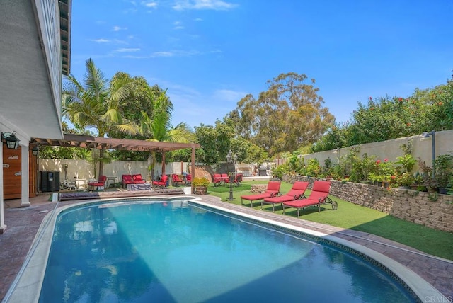 view of pool featuring a patio area and a yard