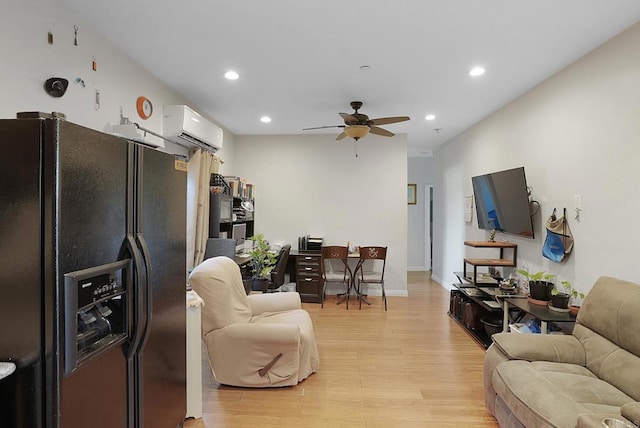 living room featuring an AC wall unit, light wood-type flooring, and ceiling fan