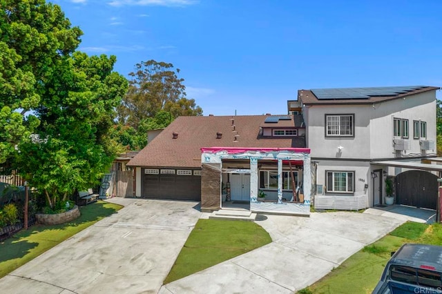 view of front of home featuring a garage and solar panels