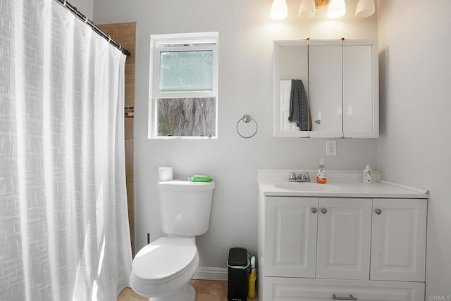 bathroom featuring tile patterned flooring, toilet, and vanity