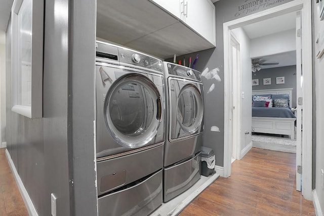 washroom featuring wood-type flooring, washing machine and dryer, and ceiling fan