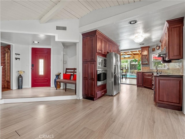 kitchen featuring appliances with stainless steel finishes, tasteful backsplash, vaulted ceiling with beams, wooden ceiling, and light wood-type flooring