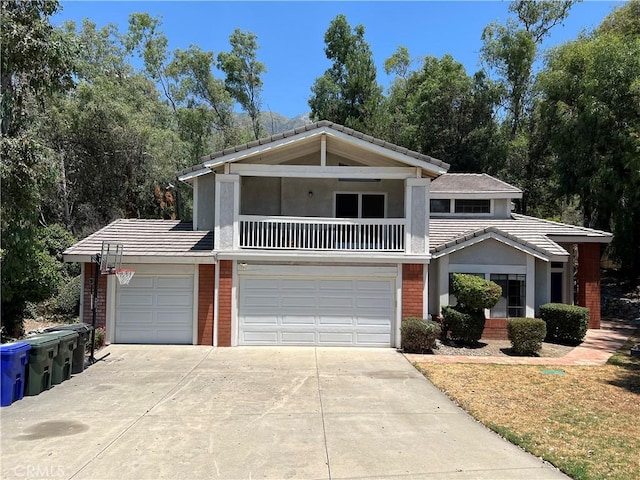 view of front of house featuring a garage and a balcony