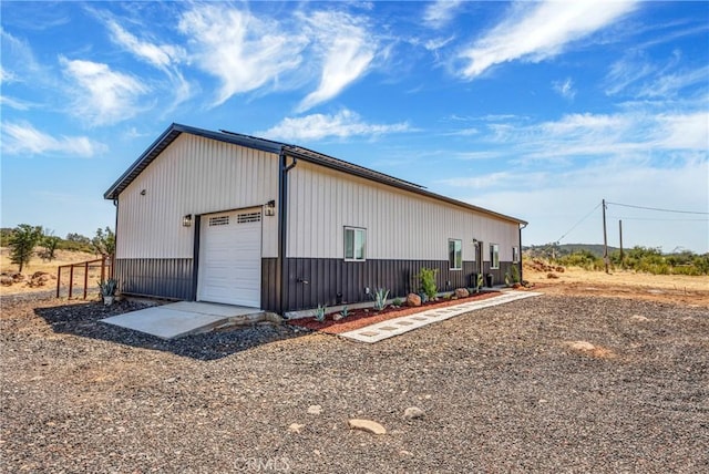 view of property exterior featuring an outdoor structure and a garage