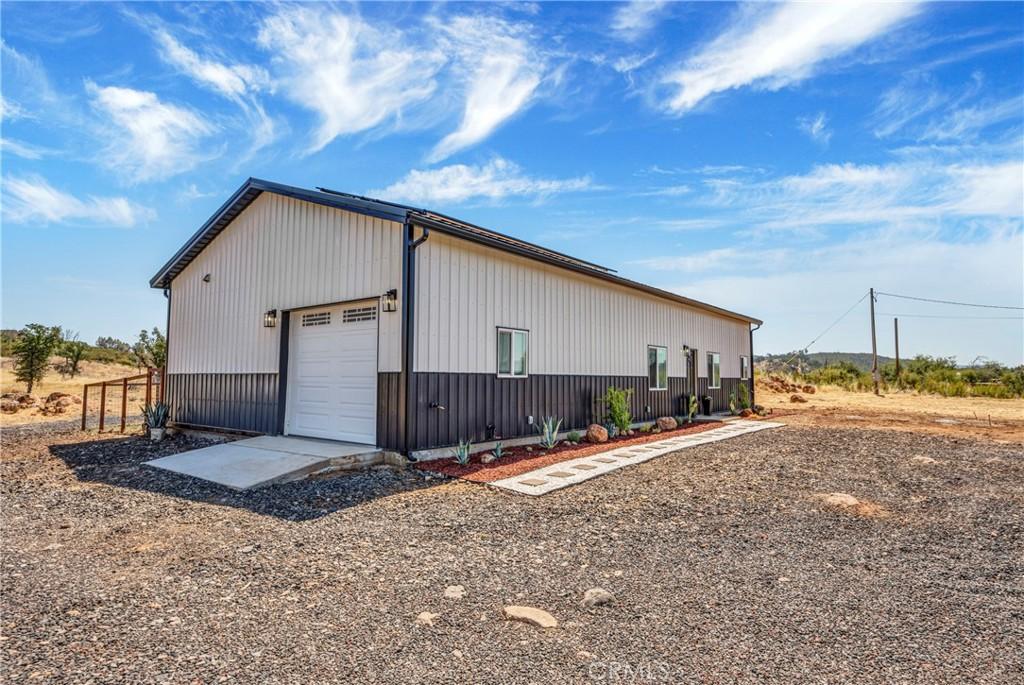 view of property exterior featuring a garage and an outbuilding