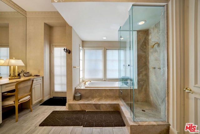 bathroom with vanity, crown molding, separate shower and tub, and wood-type flooring