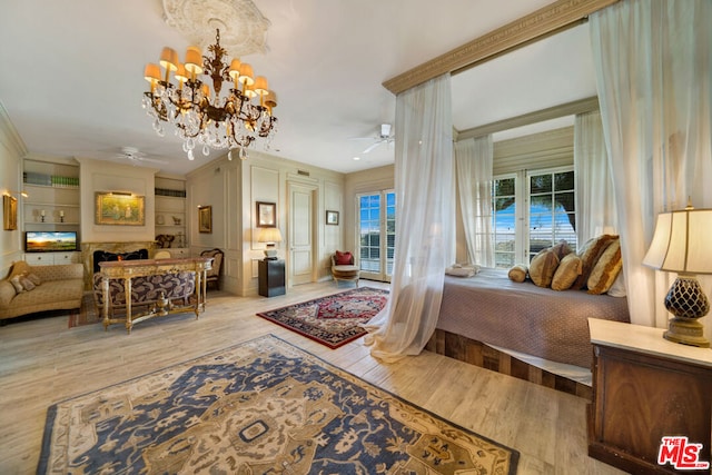 bedroom featuring a chandelier and light wood-type flooring