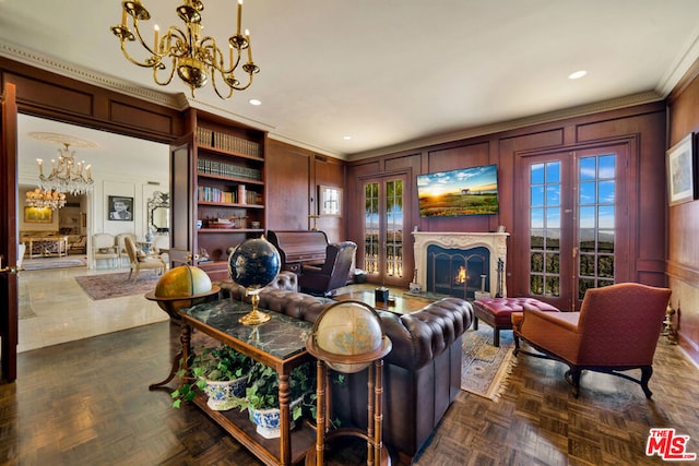 living room with french doors, crown molding, a chandelier, and dark parquet flooring