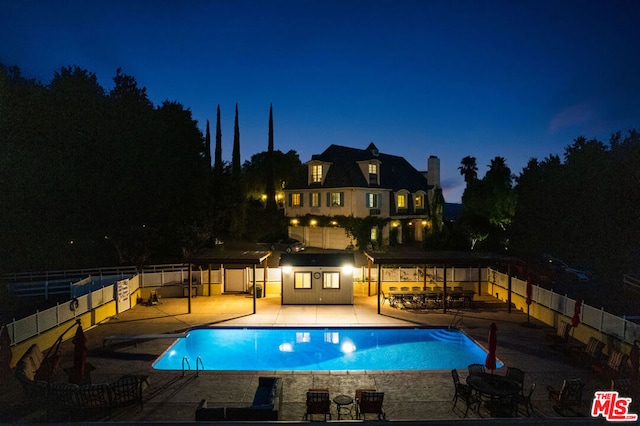 pool at night with a patio