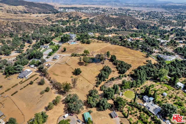 birds eye view of property featuring a mountain view