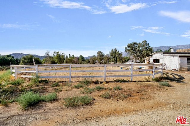 view of yard featuring a mountain view and a rural view