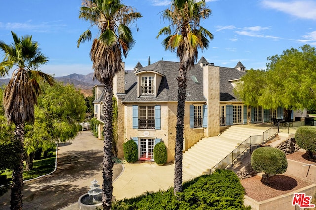 rear view of house with a mountain view