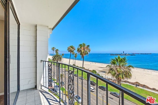 balcony with a water view and a beach view