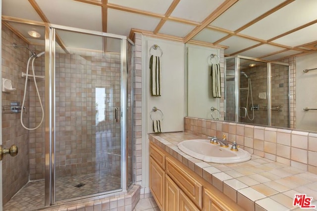 bathroom with a shower with shower door and tile patterned floors