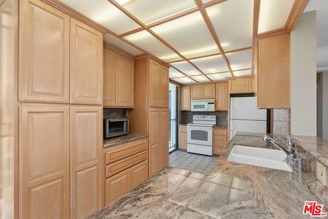 kitchen with white appliances, tasteful backsplash, light tile patterned floors, sink, and light brown cabinets