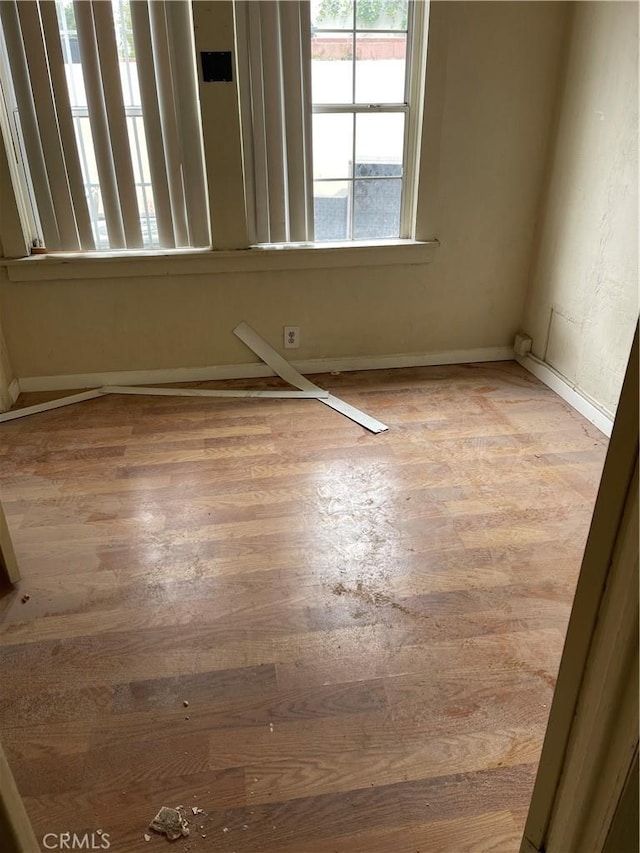 unfurnished room with wood-type flooring