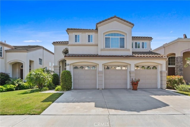 mediterranean / spanish house featuring stucco siding, driveway, an attached garage, and a tiled roof