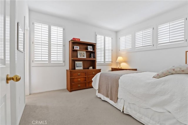 bedroom featuring baseboards and carpet