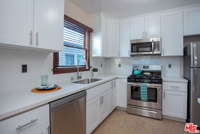 kitchen with backsplash, sink, white cabinets, and stainless steel appliances