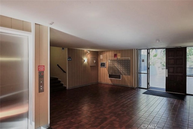 3601 W Hidden Ln Unit 121, Rolling Hills Estates, CA 90274 - unfurnished living room with wood walls and stairway